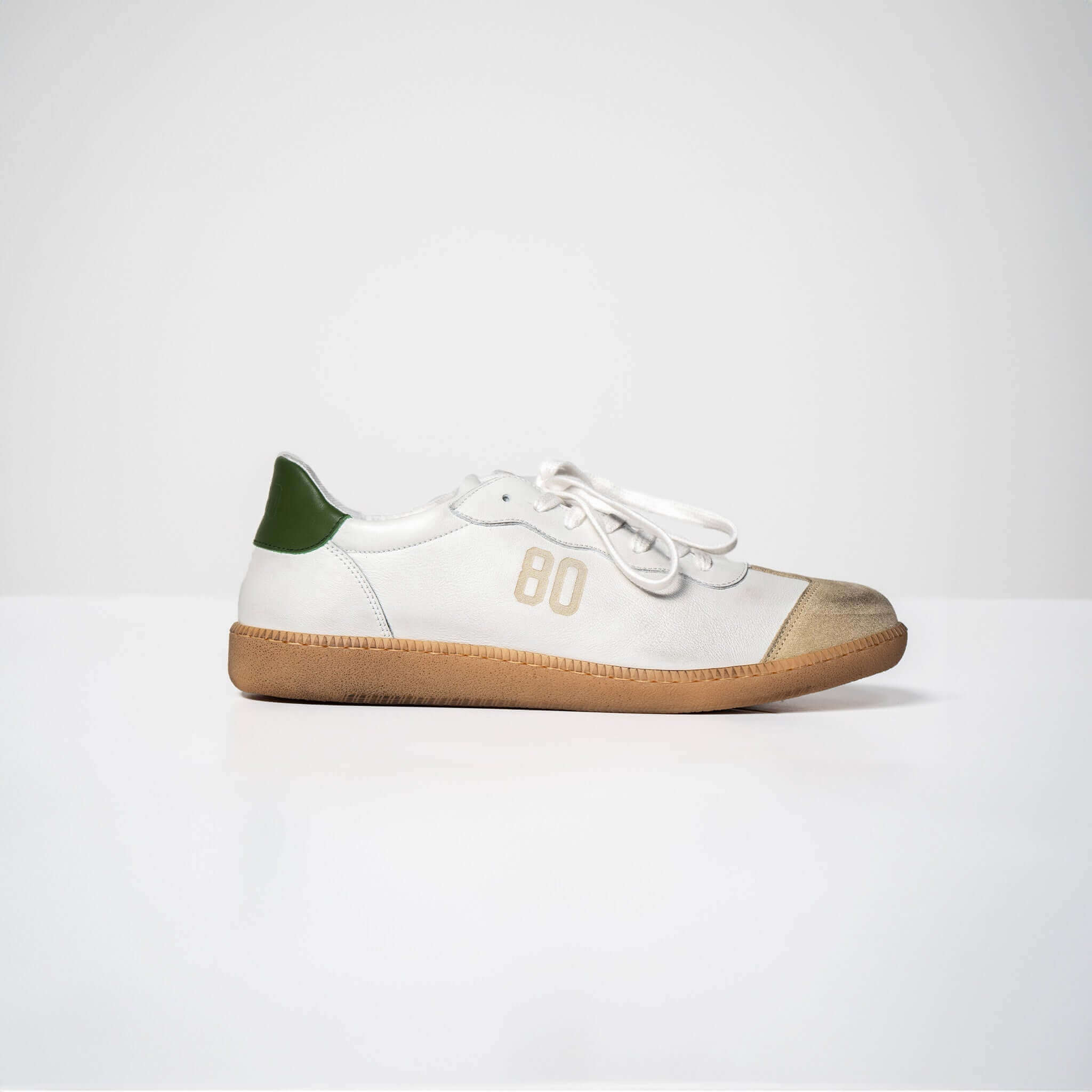 White Harvard Leather sneaker with Italian rubber sole and green heel tab, displaying number 80 on the side.