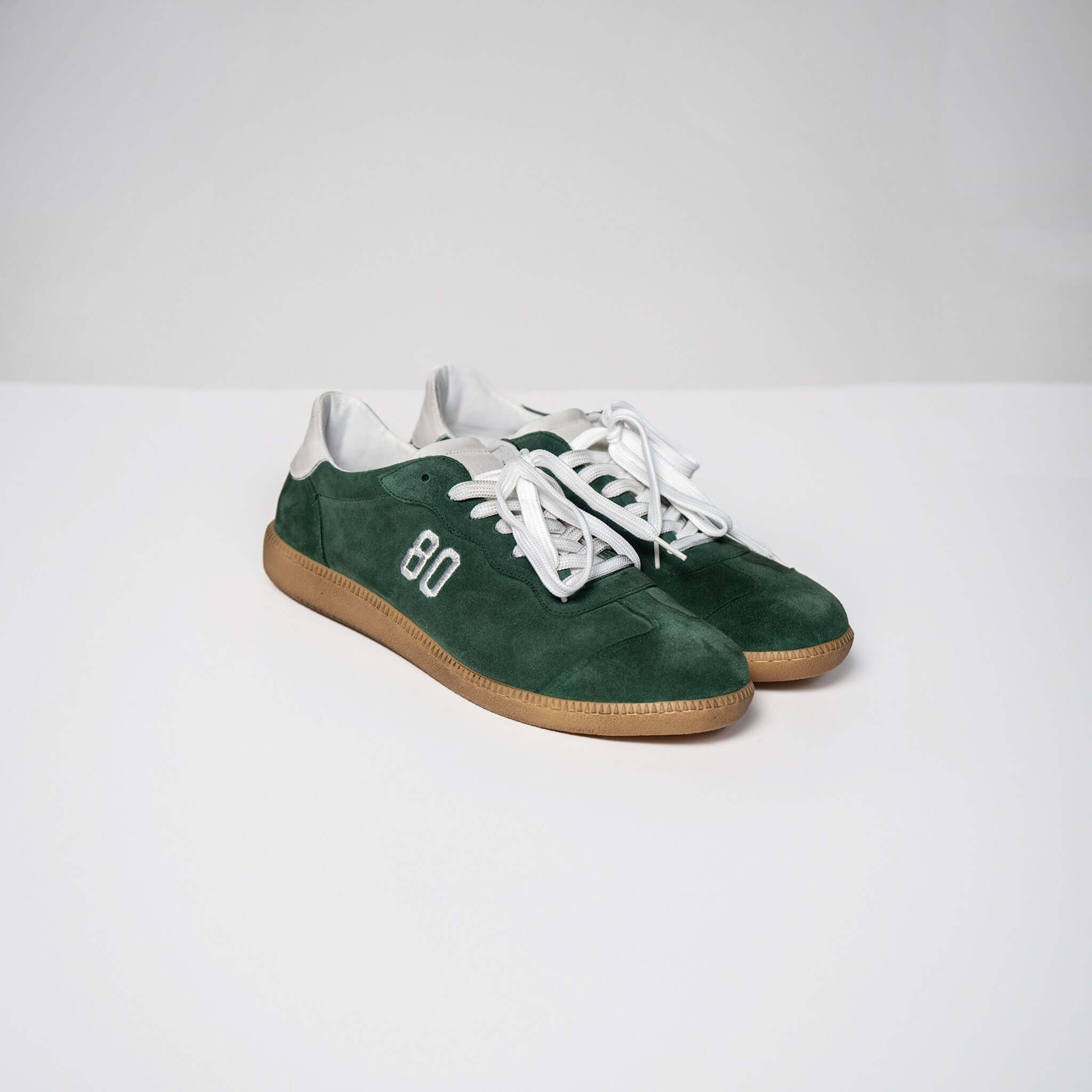 Dark green Harvard suede sneakers with white soles and laces, Made in Italy, featuring an Italian rubber sole and fine Italian suede upper.